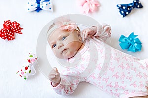 Cute adorable newborn baby child with colorful bows