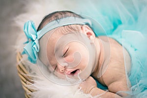 Cute and adorable newborn baby with costume sleeping