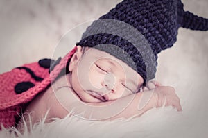 Cute and adorable newborn baby with costume sleeping