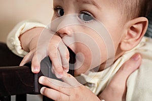 Cute adorable newborn baby playing with colorful rattle toy. baby with teether. six months old lovely baby portrait on