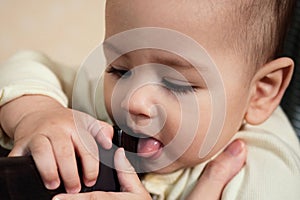 Cute adorable newborn baby playing with colorful rattle toy. baby with teether. six months old lovely baby portrait on