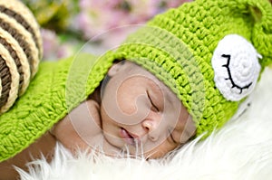 Cute adorable newborn baby sleeping on furry mat.motherhood and parenting concept.