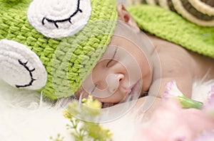 Cute and adorable newborn baby with snail costume sleeping