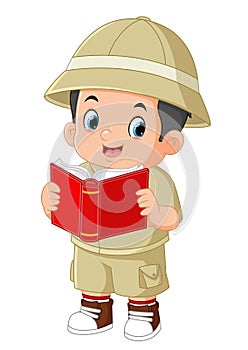 a cute adventurous boy is reading a book of folk legends photo