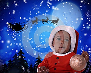Cute African American baby and Santa Claus flying in his sleigh against moon sky on background. Christmas celebration