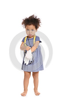 Cute African American child imagining herself as doctor while wearing rubber glove