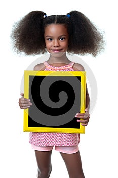 Cute african american girl holding a blank blackboard with space for text