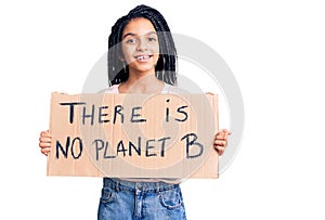 Cute african american girl holding there is no planet b banner looking positive and happy standing and smiling with a confident