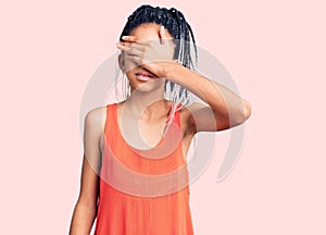 Cute african american girl wearing casual clothes covering eyes with hand, looking serious and sad