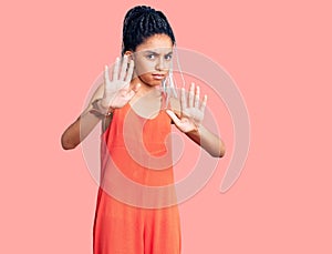 Cute african american girl wearing casual clothes moving away hands palms showing refusal and denial with afraid and disgusting