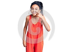 Cute african american girl wearing casual clothes pointing with hand finger to face and nose, smiling cheerful