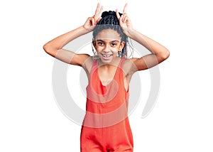 Cute african american girl wearing casual clothes posing funny and crazy with fingers on head as bunny ears, smiling cheerful