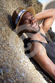 Cute african american guy smiling outdoors with hat