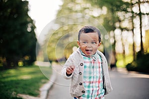 Cute african american toddler having fun outdoors photo