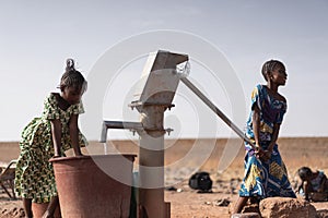 Cute African Ethnicity Infants Gathering healthful Water in a rural village