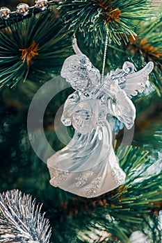 Cute angel is a glass toy hanging and decorating the Christmas tree