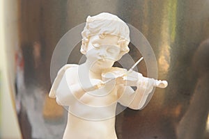 Cute angel playing violin