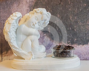 Cute angel sculpture. Coffee beans