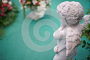 Cute Angel statue in the garden. Beautiful, thais, cupid