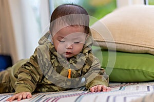 Cute Asian Baby boy with camouflage jacket