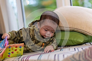 Cute Asian Baby boy with camouflage jacket