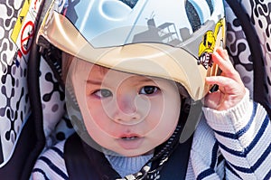 Cute Asian baby boy in a protective helmet