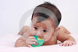 Cute Asian Baby Girl Biting Rubber Toy