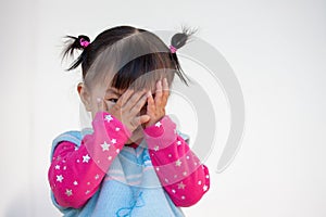 Cute asian baby girl closing her face and playing peekaboo or hide and seek