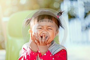 Cute asian baby girl laughing and playing peekaboo or hide and seek