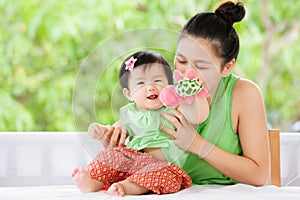 Cute asian baby girl smiling and playing with her mother