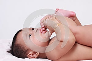 Cute Asian Baby Girl Sucking Her Toes