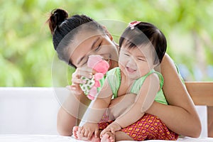 Cute asian baby girl smiling and playing with her mother