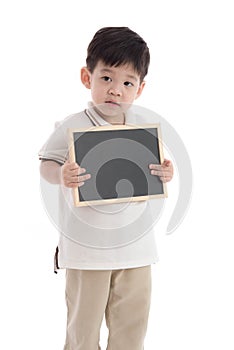 Cute asian boy holding chalkboard on white background