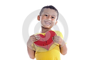 Cute asian boy holds a heart