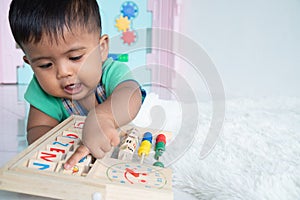 Cute asian boy play toy in room