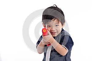 Cute asian boy playing toy gun