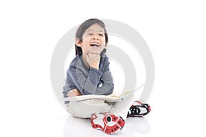 Cute asian boy reading a book