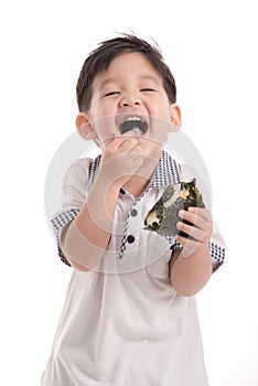 Cute asian child eating rice ball or onigiri