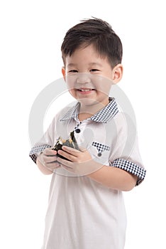 Cute asian child eating rice ball or onigiri