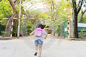 Cute asian child girl with backpack running and going to school with fun