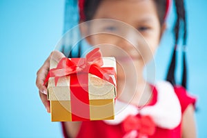 Cute asian child girl holding beautiful gift in hand