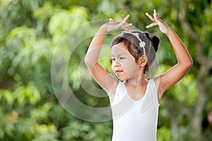 Cute asian child girl is practicing a ballet