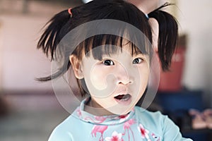 Cute Asian child girl is smiling happily