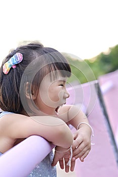 Cute Asian child girl is smiling happily in the park.