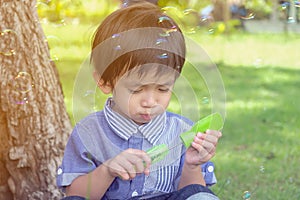 Cute Asian child playing with bubbles