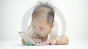 Cute Asian Chinese baby flipping a book