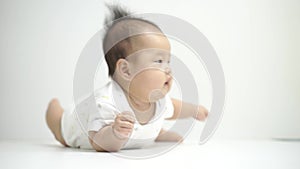 Cute Asian Chinese baby rolling on her tummy
