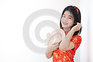 Cute Asian Chinese lady in Qipao traditional dress smiling with white space for text