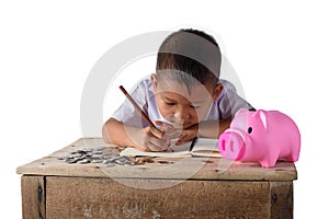 Cute asian country boy Make a note of income receipts and coins with piggy bank isolated on white background