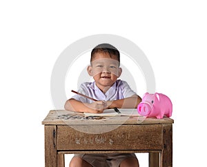 Cute asian country boy Make a note of income receipts and coins with piggy bank isolated on white background